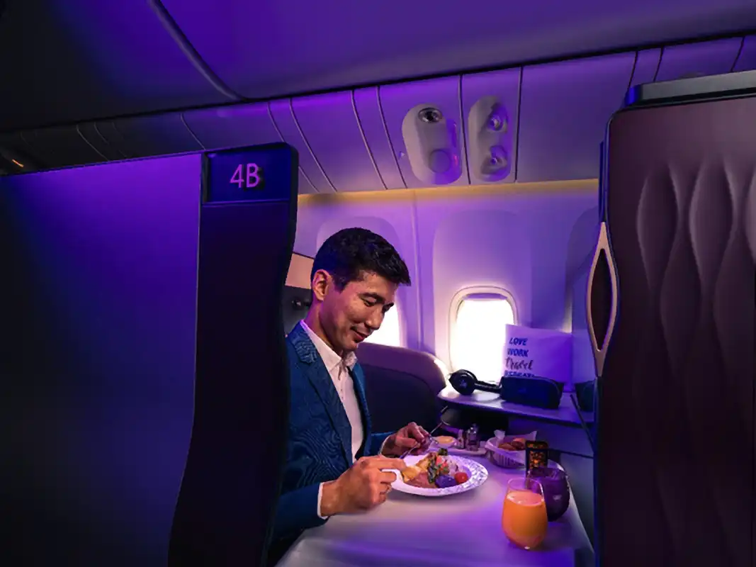 Passenger enjoying Qatar Airways Qsuite